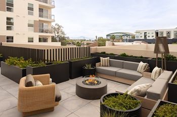Rooftop deck with gaming lounge, dog run, bbq grills, and fire pits